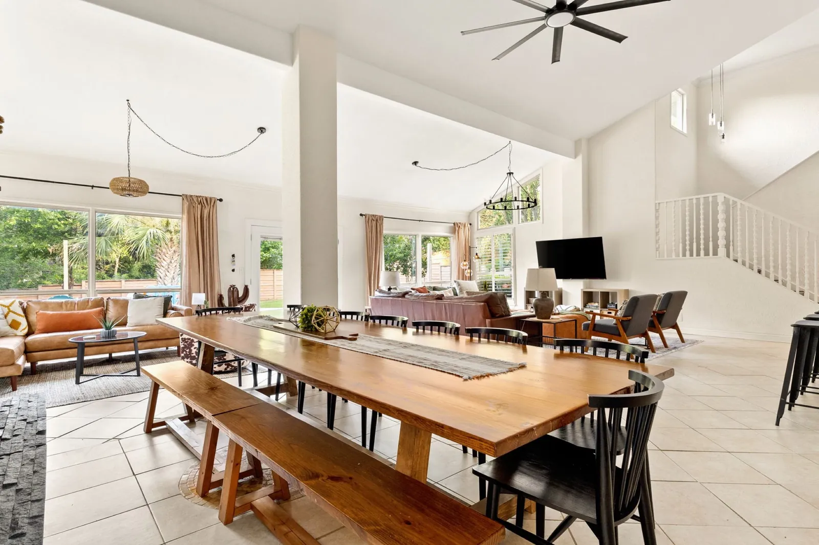 The long farm table with black spindle chairs, looking across the great room