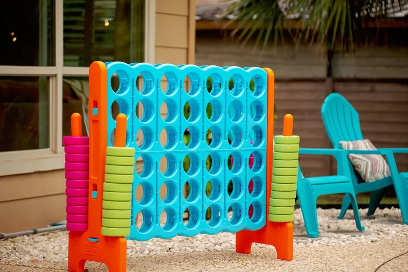 Giant Connect Four in bright blue and orange by the patio