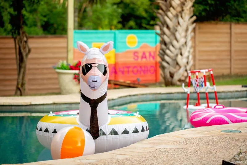 A llama pool float in sunglasses and a tie