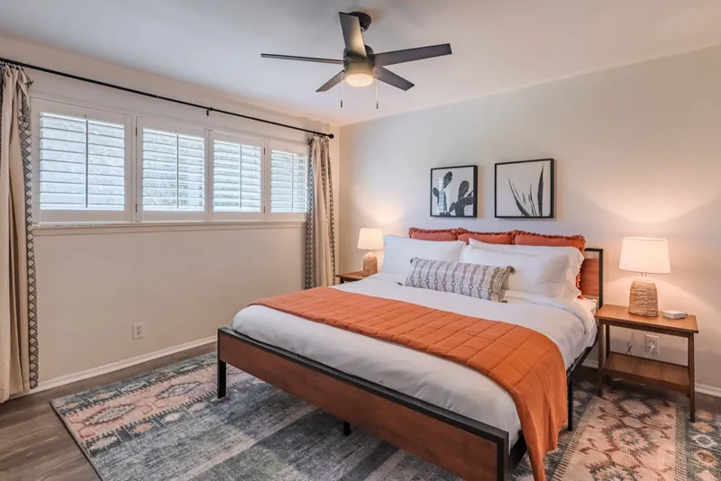 Cactus room after: a rust bedspread, a Southwest rug and black-and-white cactus prints