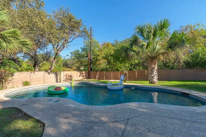 The pool in 2023: clean blue water and a few floats