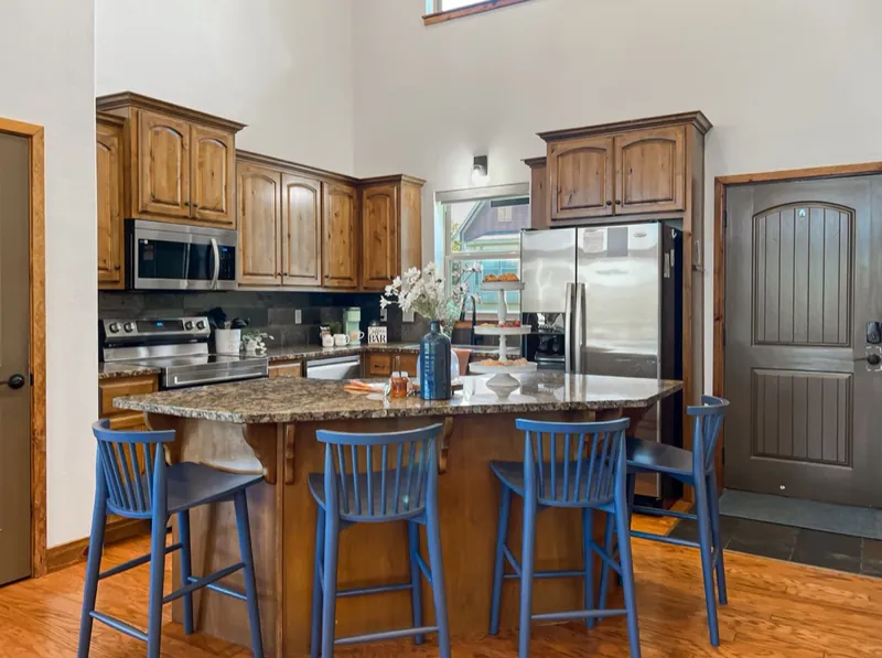 Kitchen after: navy stools at the island