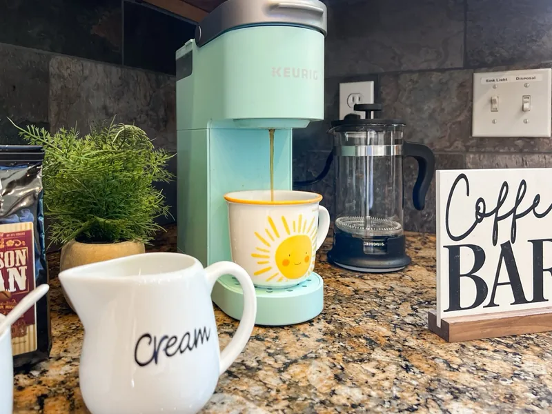 Coffee bar with a mint coffee maker and a Coffee Bar sign