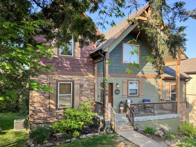 The front of Deep Forest Retreat after, with landscaping and a welcoming porch