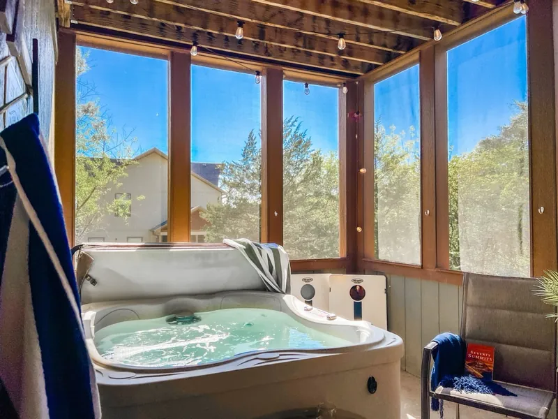 Hot tub porch after, with string lights
