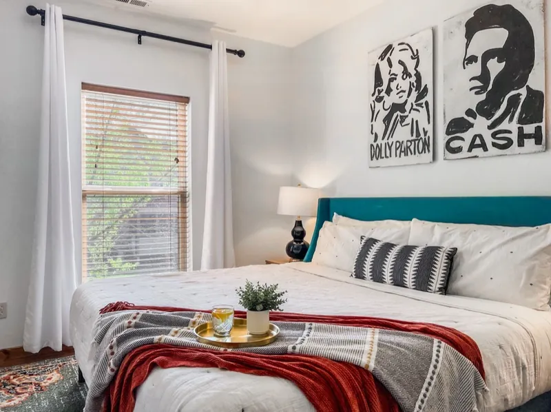 Dolly and Cash room in 2023: Dolly Parton and Johnny Cash art and a teal headboard