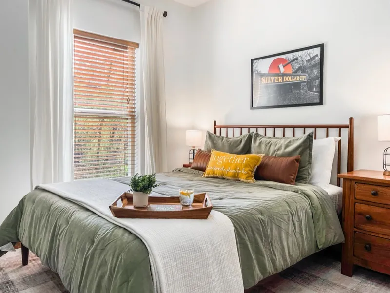 Queen and bunk room after: sage greens and Silver Dollar City art