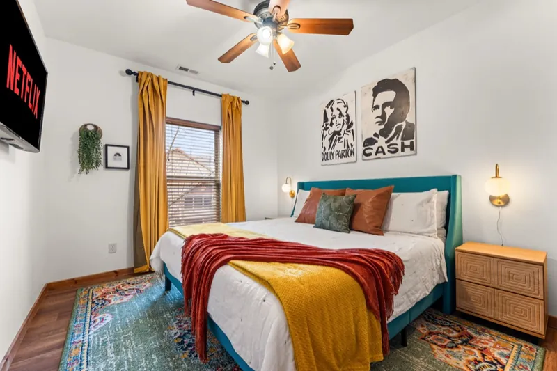 Dolly and Cash room in 2026: gold curtains, a patterned rug and Dolly and Cash art