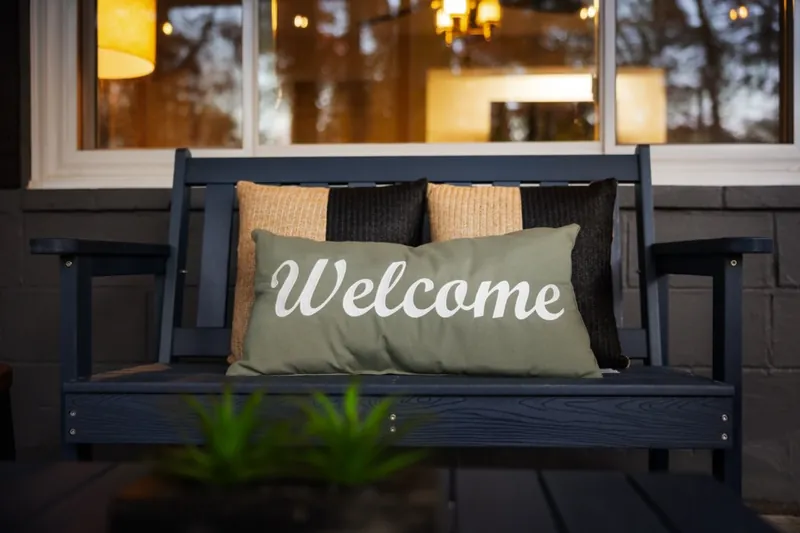 Porch swing with a Welcome pillow