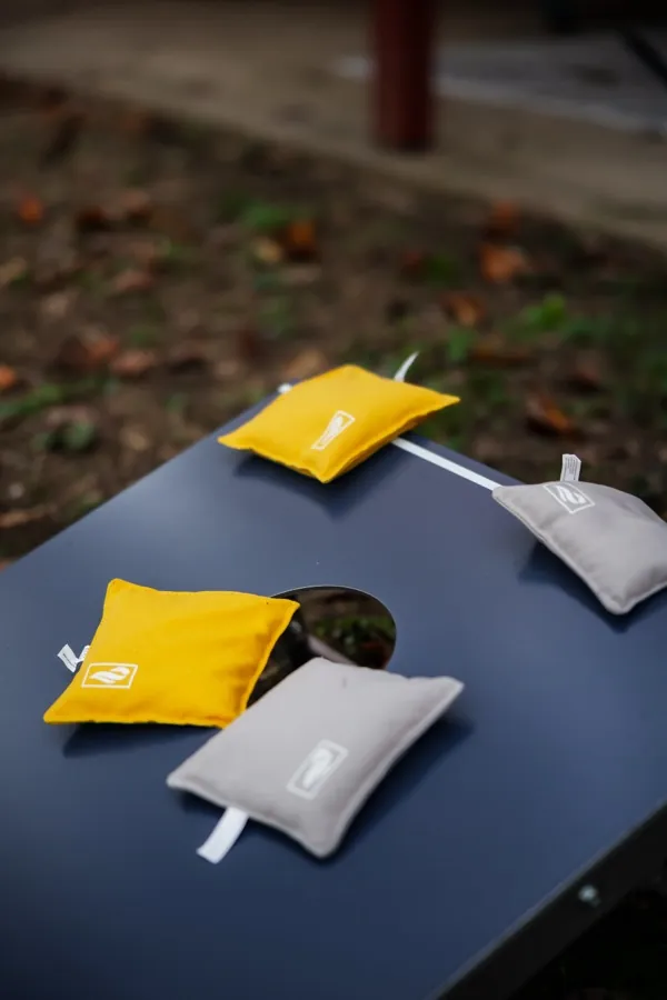 Cornhole board and bags in the yard