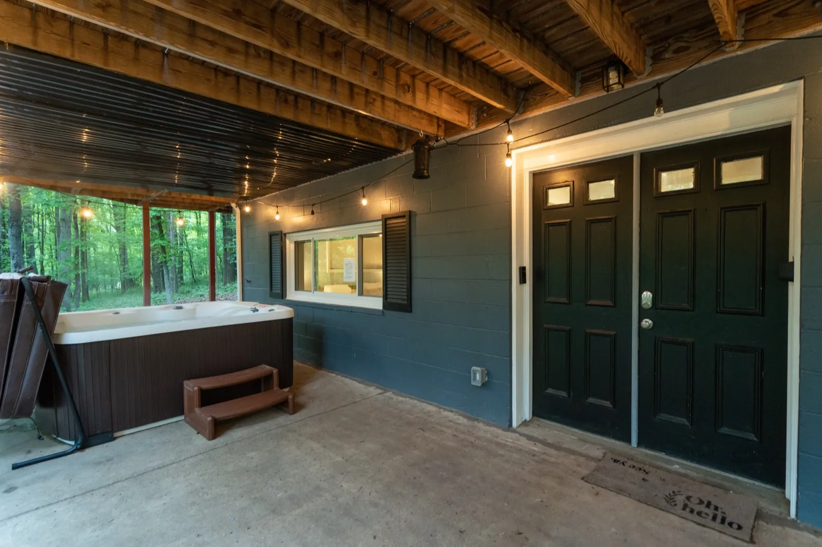 Lower patio before: bare concrete by the hot tub