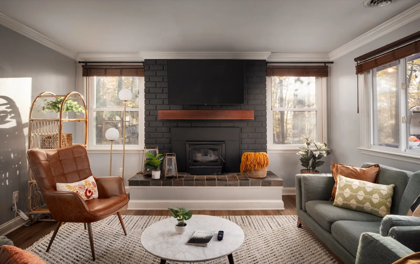 Living room after: a neutral rug, leather chair and new pillows