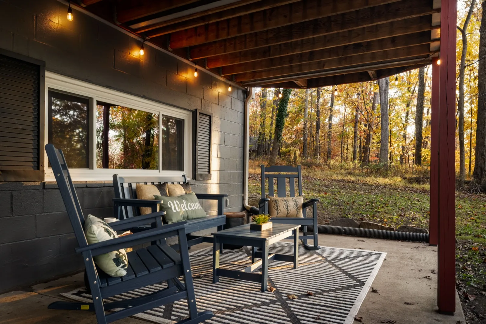 Lower patio after: rockers, a porch swing and a rug under the deck