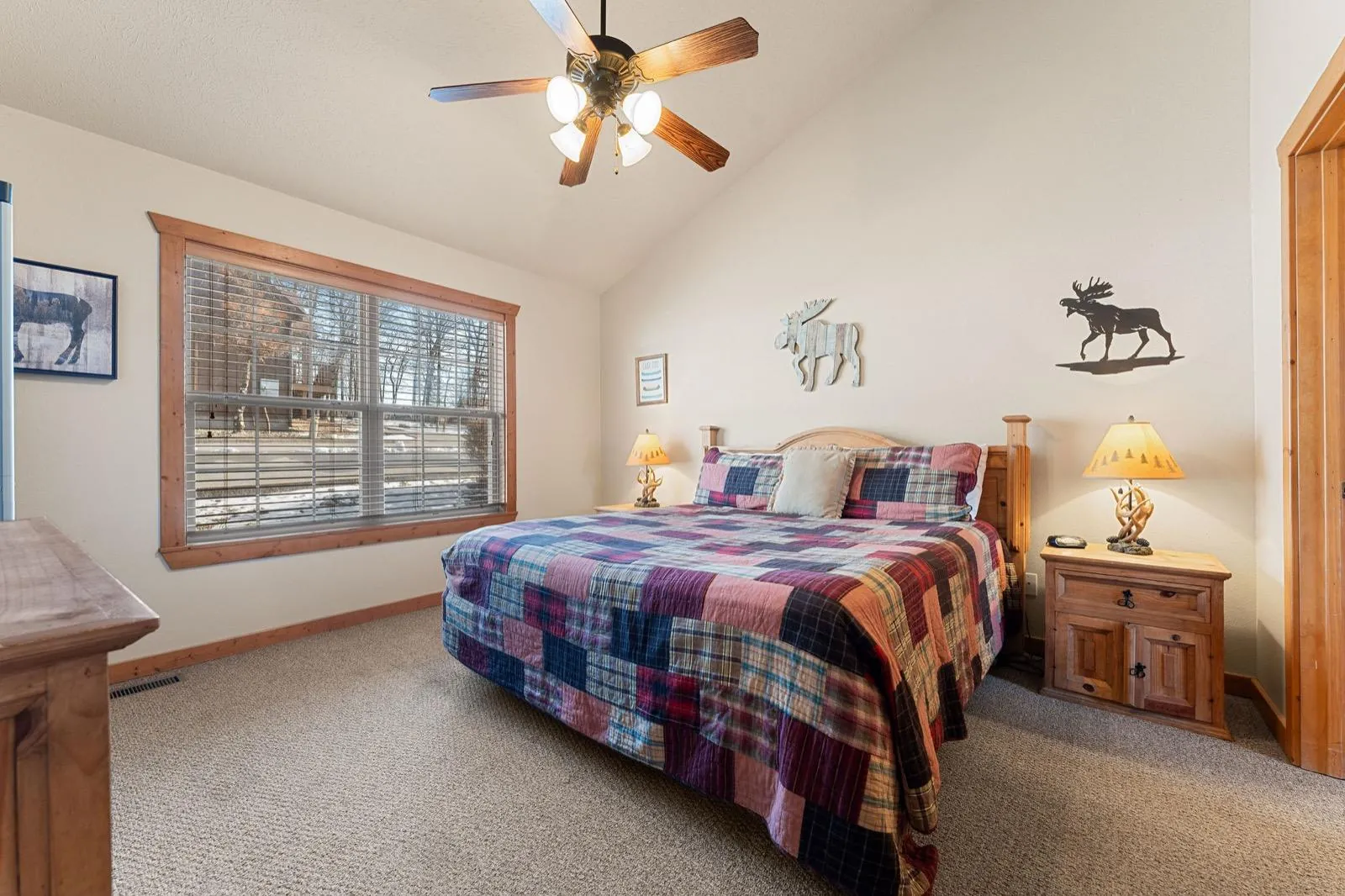Moose room before: patchwork quilt and scattered moose art