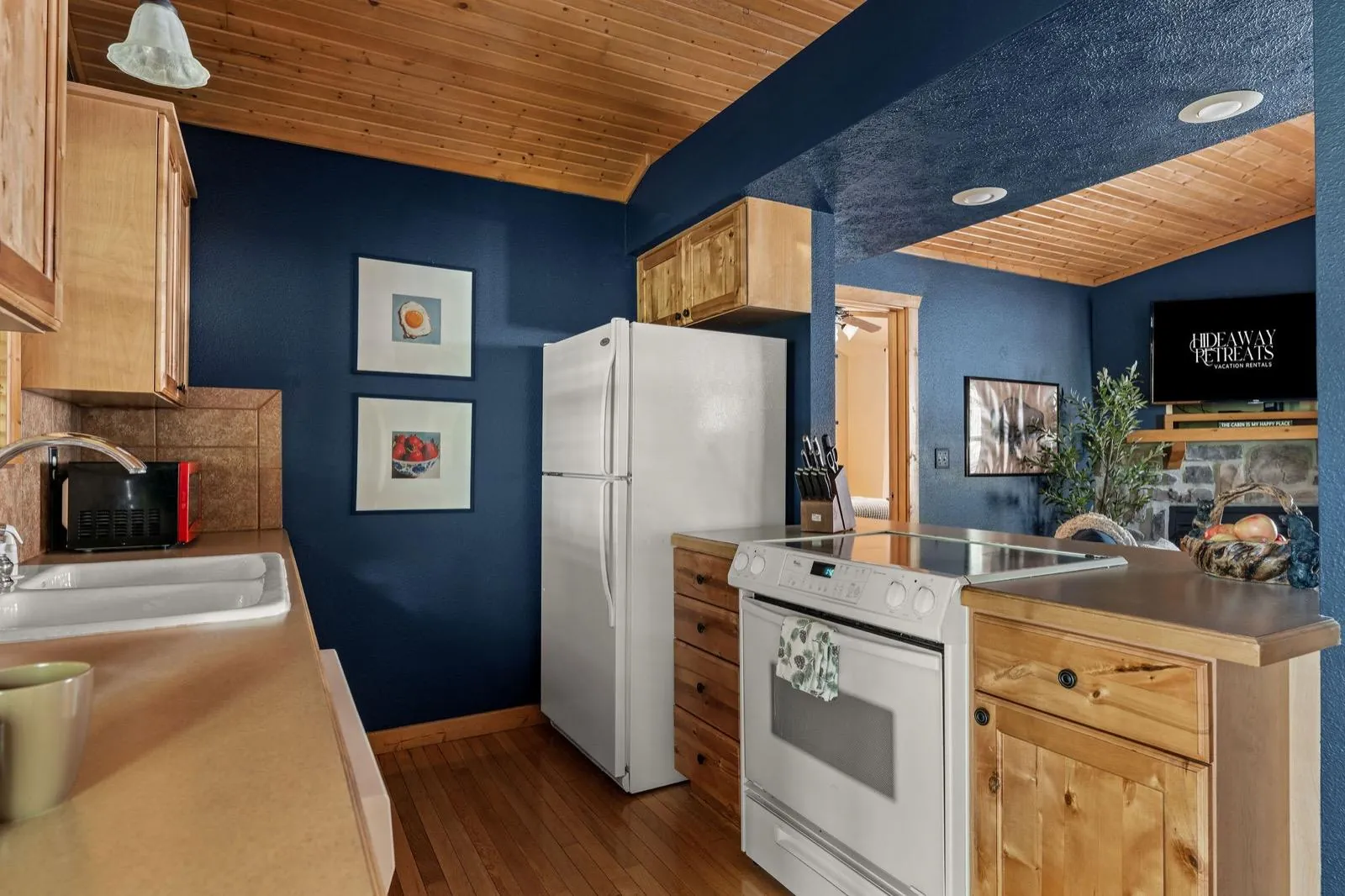 Kitchen after: navy walls with framed food prints