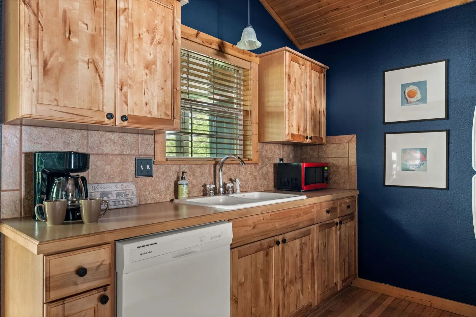Kitchen with framed food prints on navy walls