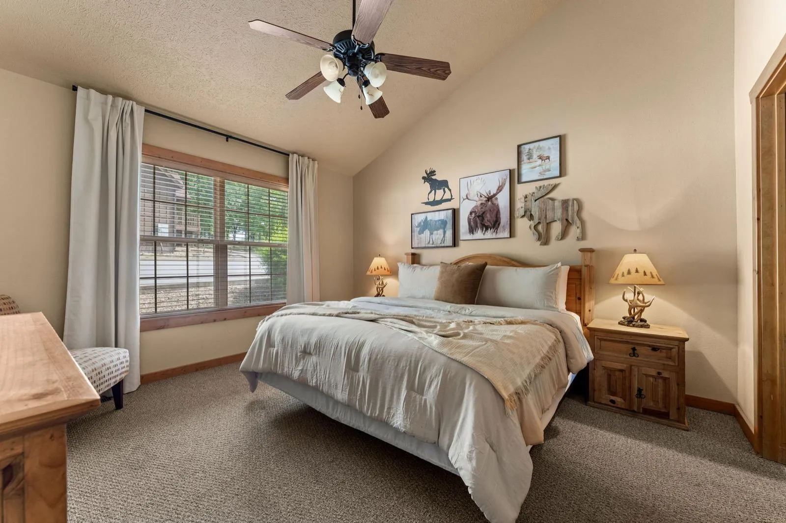 Moose room after: a moose gallery wall above neutral bedding