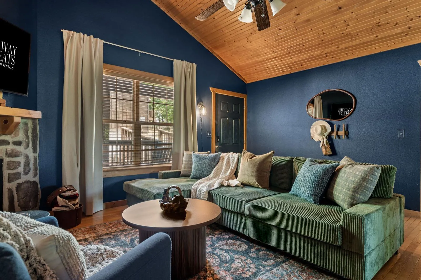Green corduroy sectional with layered pillows