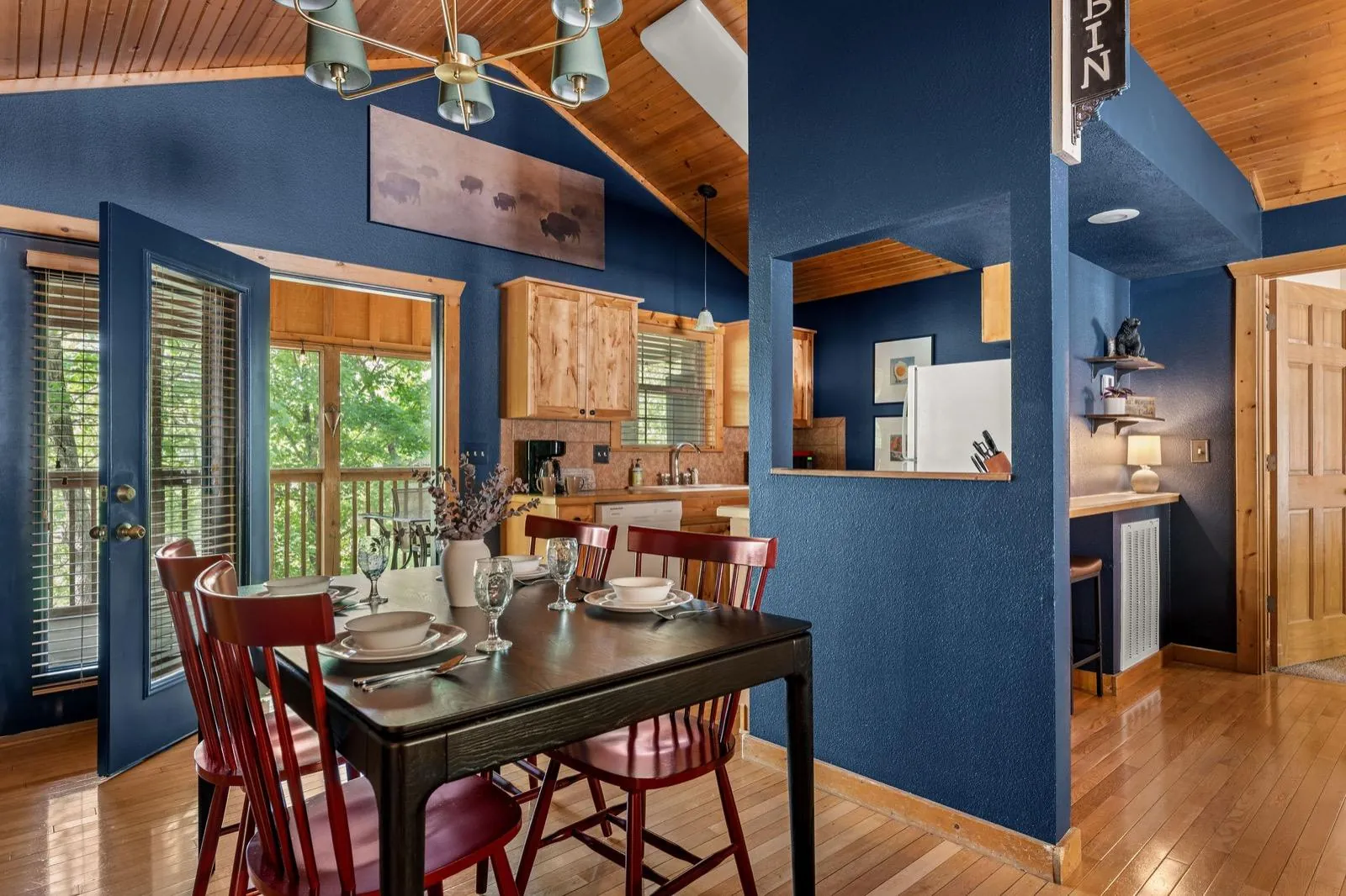 Dining after: a black table and red spindle chairs