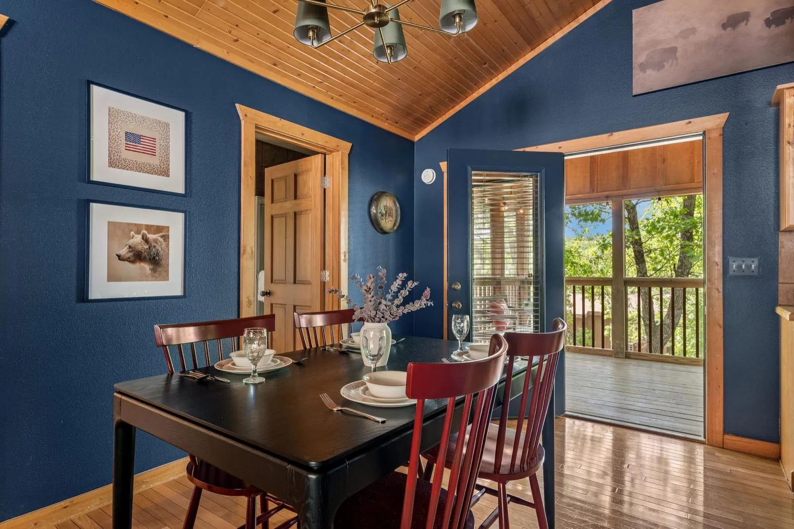 Set dining table beneath framed art