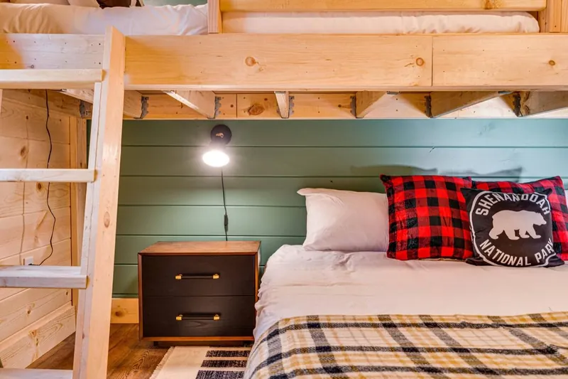 Close-up of the bunks with a bear pillow and plaid throw