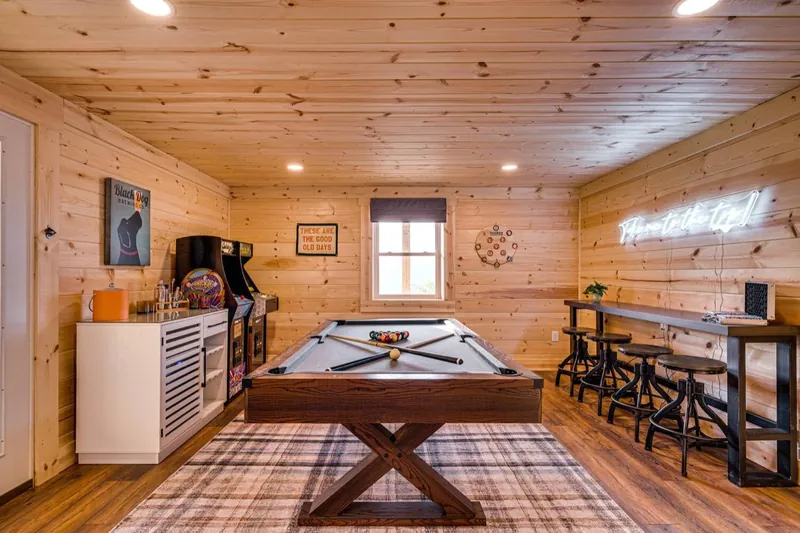 Game room with a pool table and bar seating
